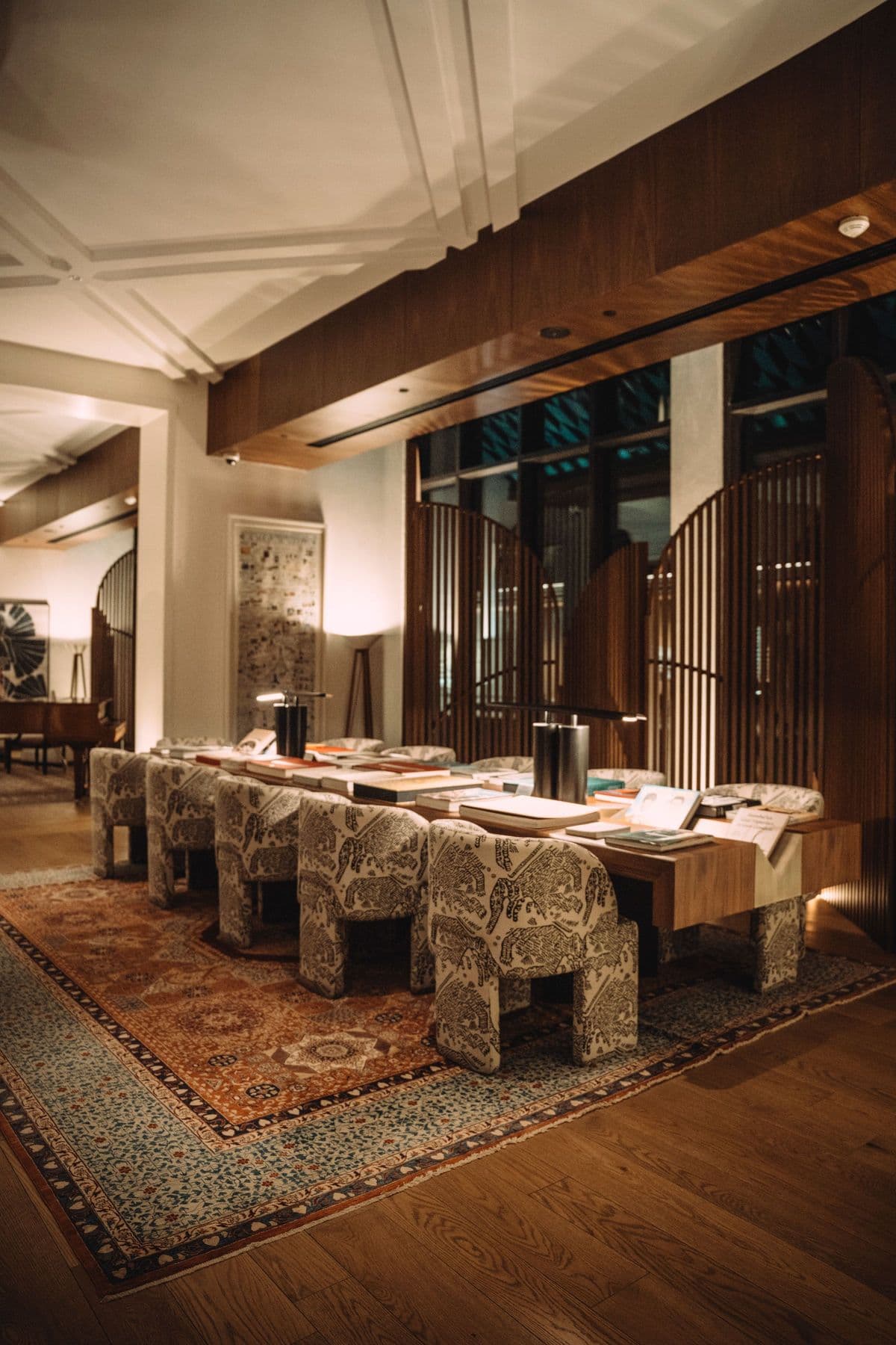 Upscale restaurant dining room with warm lighting and a patterned rug