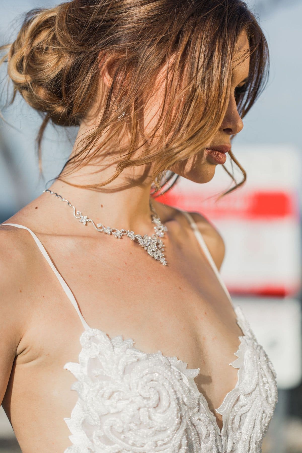 Editorial portrait of a woman with a diamond necklace and a softly pinned updo
